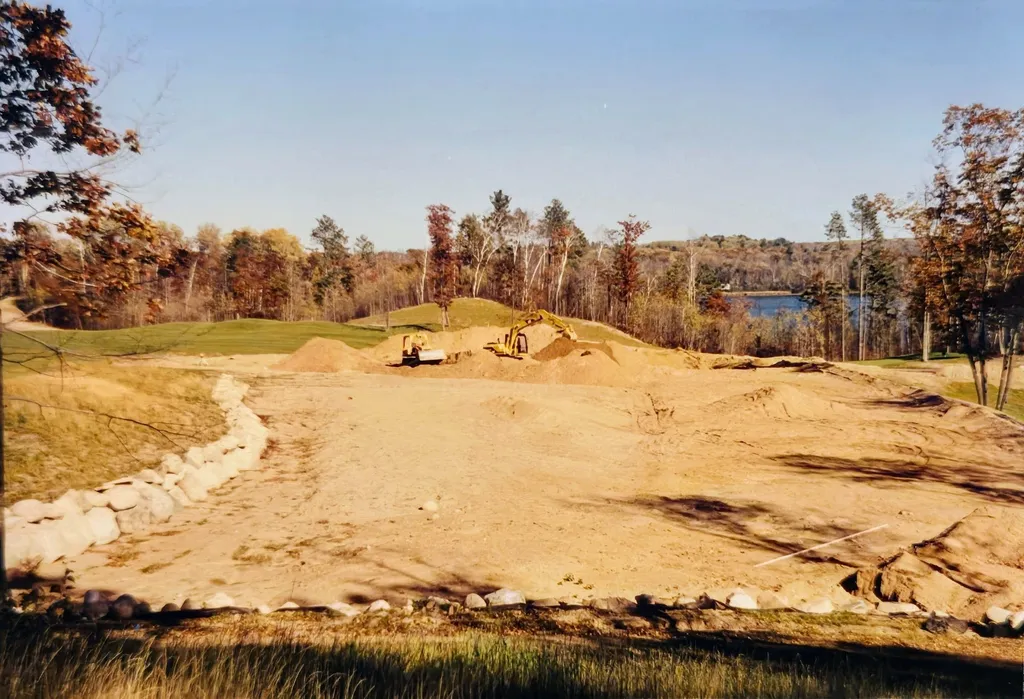 Bulldozers grading a bunker complex with Eagle Lake visible in the background