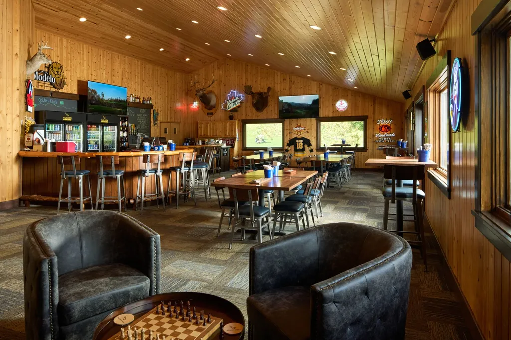 Leather lounge chairs around a chess board with dining tables in the background at the Golden Eagle clubhouse