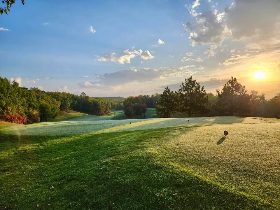 Scenic view across the property with rolling fairways and Northwoods treeline